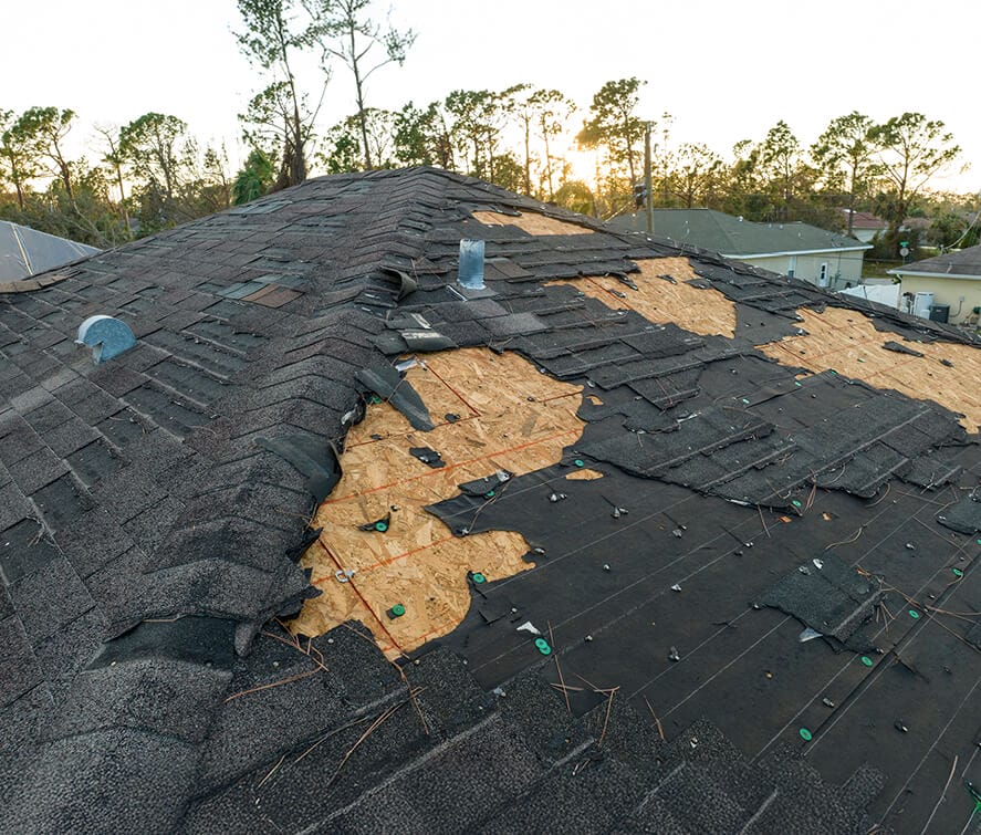 a damaged black roof being repaired, roof repair, affordable roofing company