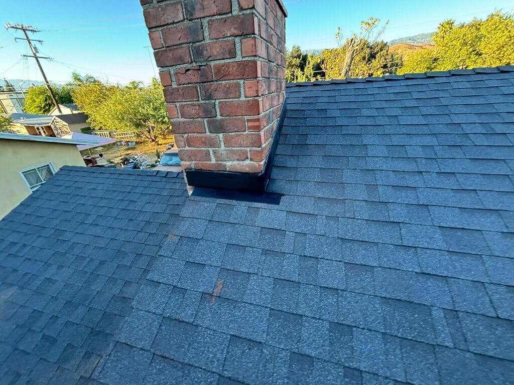 new gray roof and chimney, commercial roofing companies near me